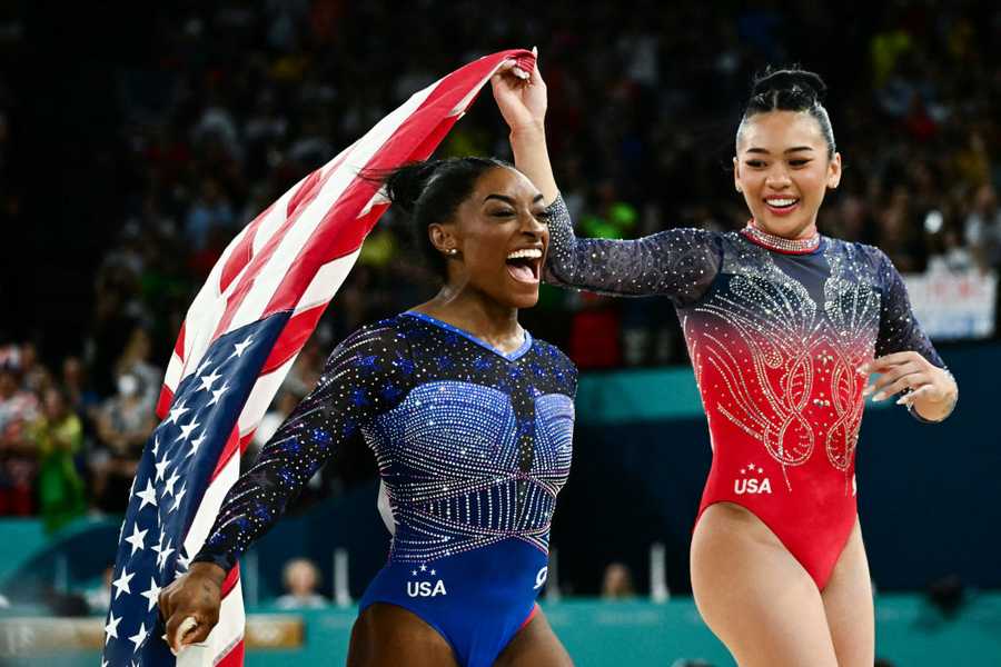 TOPSHOT-GYMNASTICS-ARTISTIC-OLY-PARIS-2024 TOPSHOT - Winner US' Simone Biles and third-placed US' Sunisa Lee celebrate after the artistic gymnastics women's all around final during the Paris 2024 Olympic Games at the Bercy Arena in Paris, on August 1, 2024. (Photo by Loic VENANCE / AFP) (Photo by LOIC VENANCE/AFP via Getty Images)