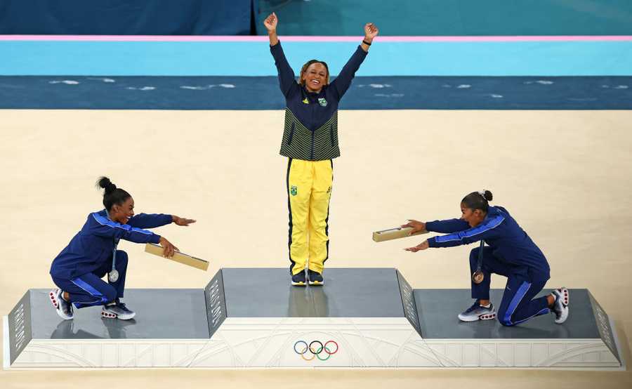 Artistic Gymnastics - Olympic Games Paris 2024: Day 10 PARIS, FRANCE - AUGUST 05: Gold medalist Rebeca Andrade (C) of Team Brazil, silver medalist Simone Biles (L) of Team United States and bronze medalist Jordan Chiles (R) of Team United States celebrate on the podium at the Artistic Gymnastics Women's Floor Exercise Medal Ceremony on day ten of the Olympic Games Paris 2024 at Bercy Arena on August 05, 2024 in Paris, France. (Photo by Elsa/Getty Images)